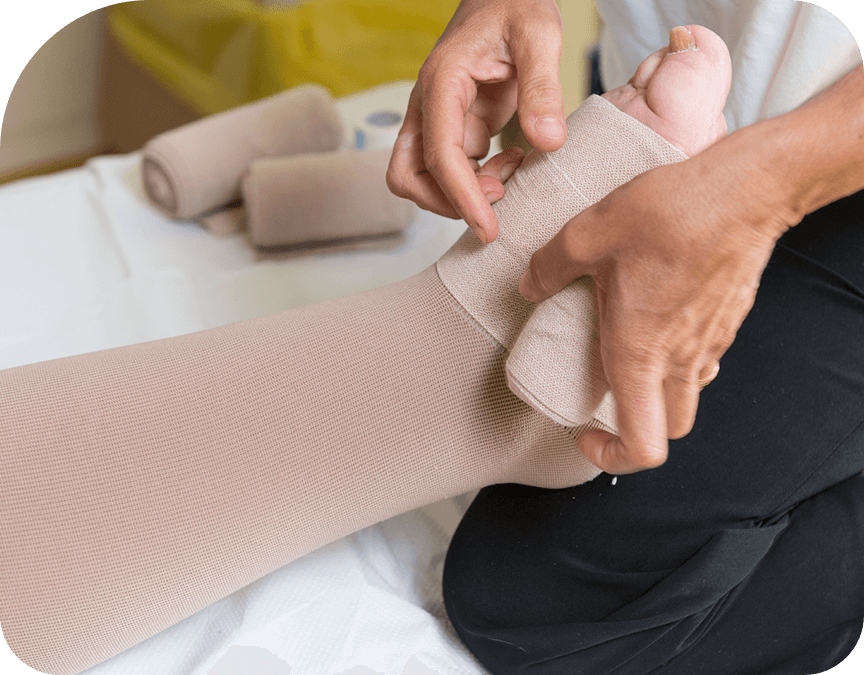 Healthcare worker helping patient with compression stockings