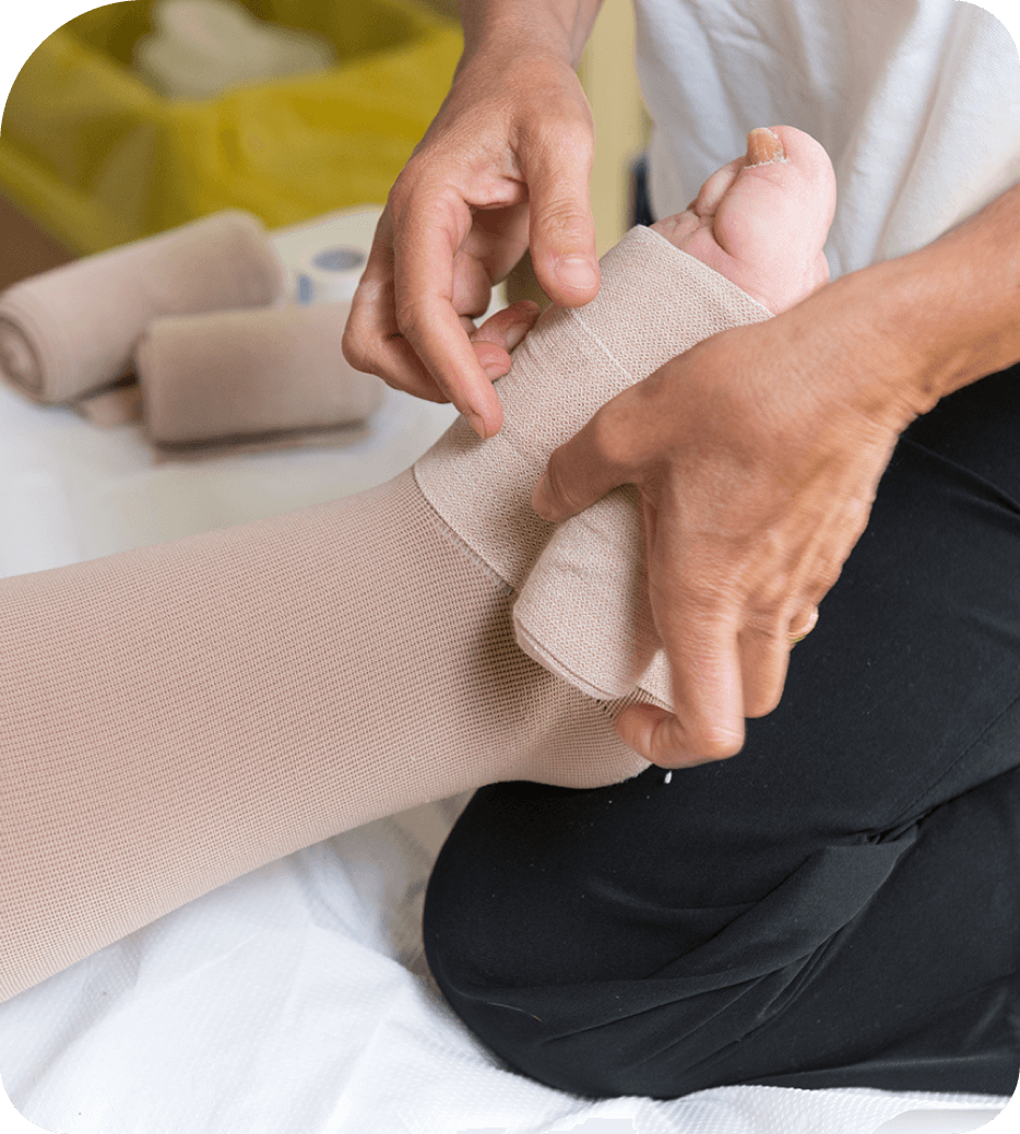 Healthcare worker helping patient with compression stockings