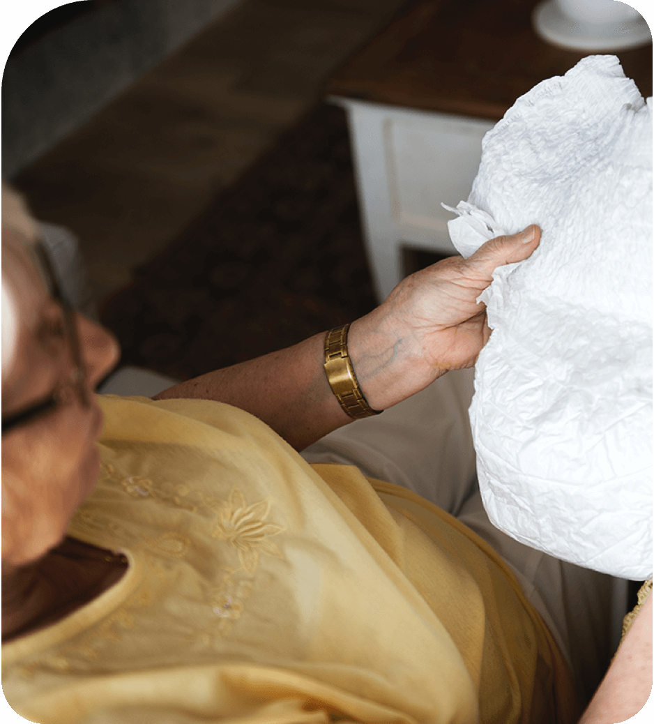 Elderly woman holding incontinence product