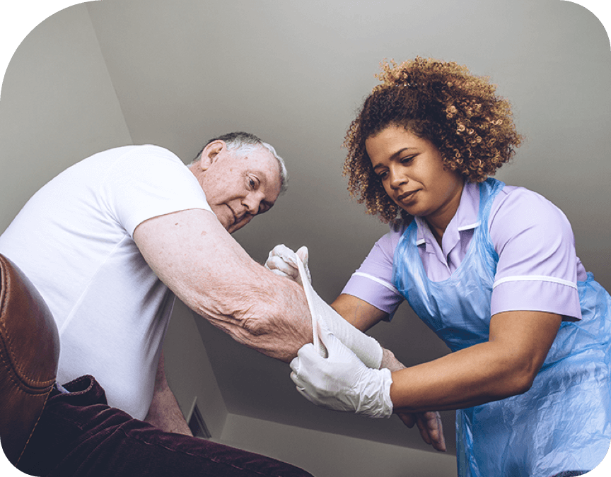 Healthcare worker bandaging a man's arm wound