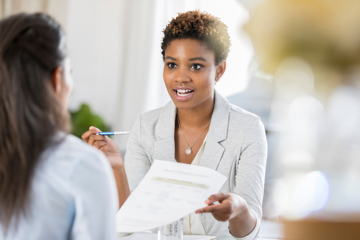 Businesswomen meet to discuss document